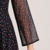 elrare black scatter floral maxi dress seated